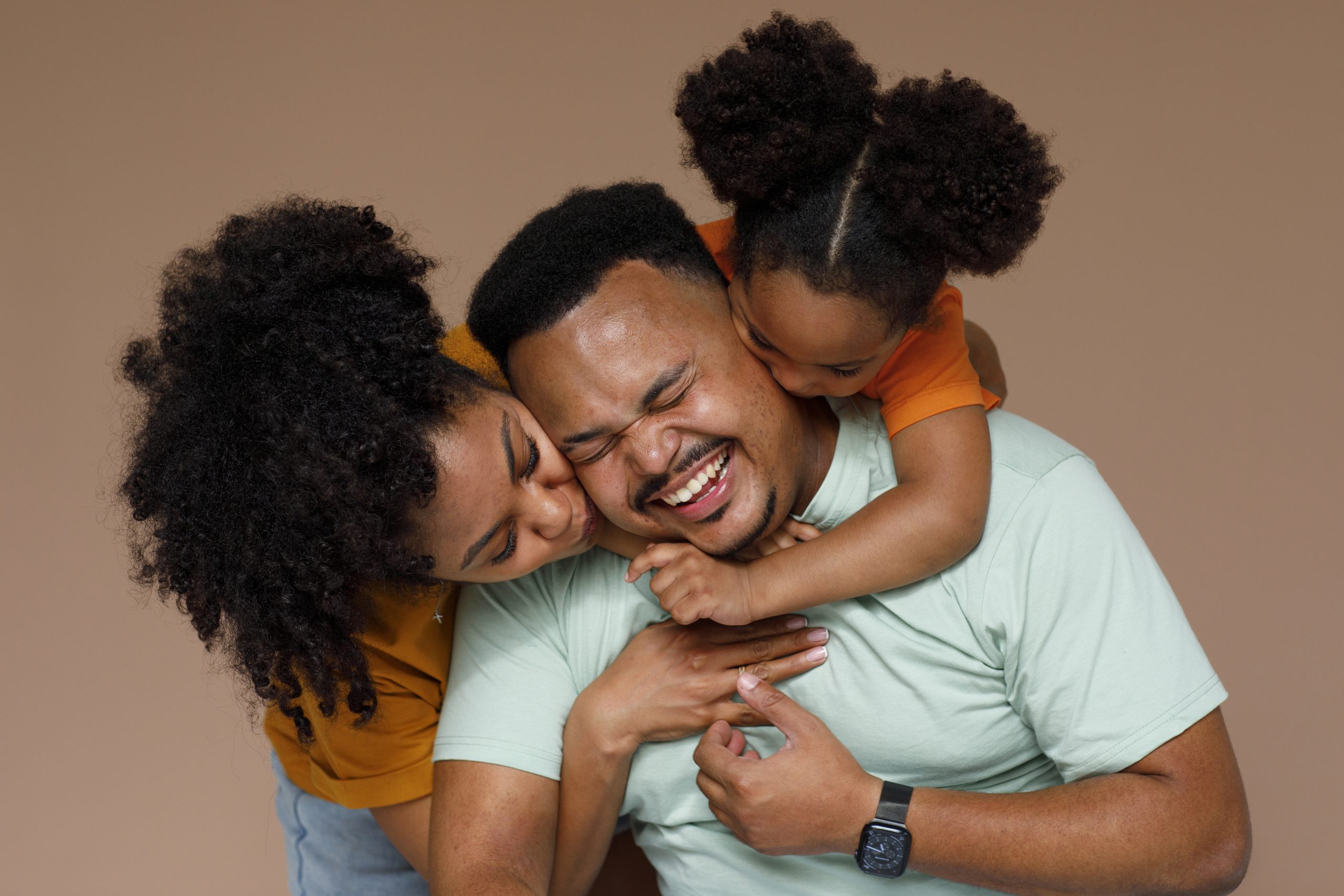 front view black family posing studio scaled